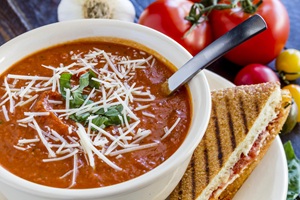 Artisanal-tomato-soup-with-shredded-cheese-min