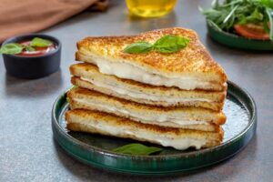 Sliced,Fried,Sandwich,With,Melted,Mozzarella,On,A,Plate,Served